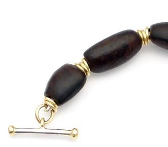 Close-up of African blackwood and gold necklace.